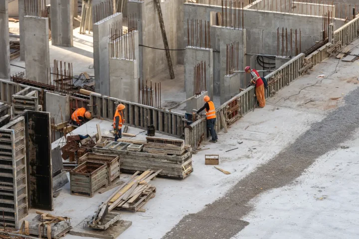 Construction site with dewatering pump market actively removing water from a deep excavation to maintain a dry, stable work area.