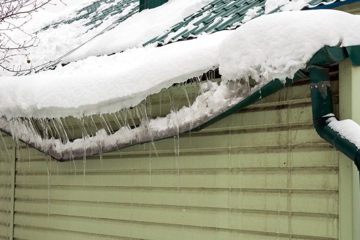 Devastating water damage from frozen pipes in a home, showing ruined ceilings, walls, and belongings, representing costly insurance claims.